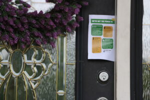 A flyer is seen hanging on a door.